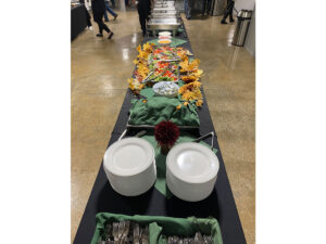 The buffet line with plates and food at the First Annual Pollinator Project Gala