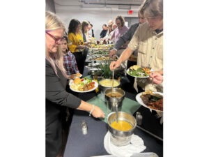 Attendees in line at the buffet getting food